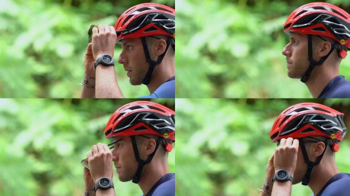 自行车比赛骑手：调整眼镜并开始