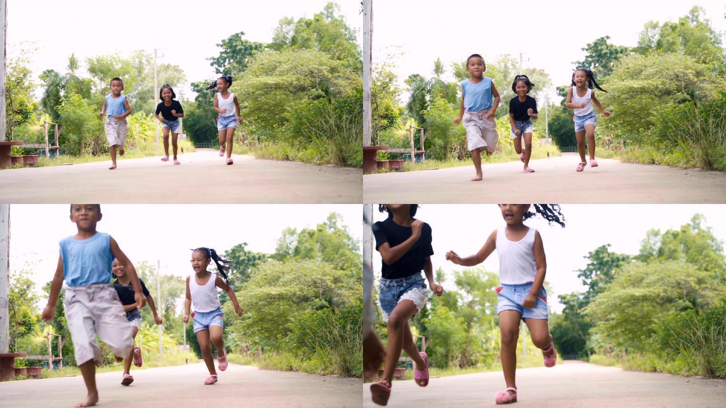 快乐的男孩和女孩快乐地奔跑，慢动作地笑。