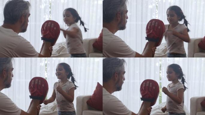 父亲训练女儿拳击。
