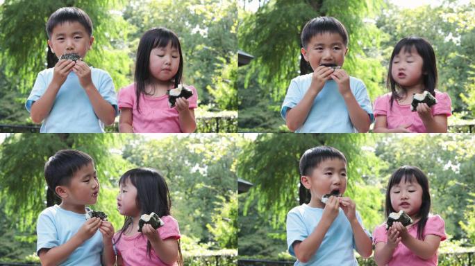 孩子在户外吃饭团日本小学生孩子日式美食