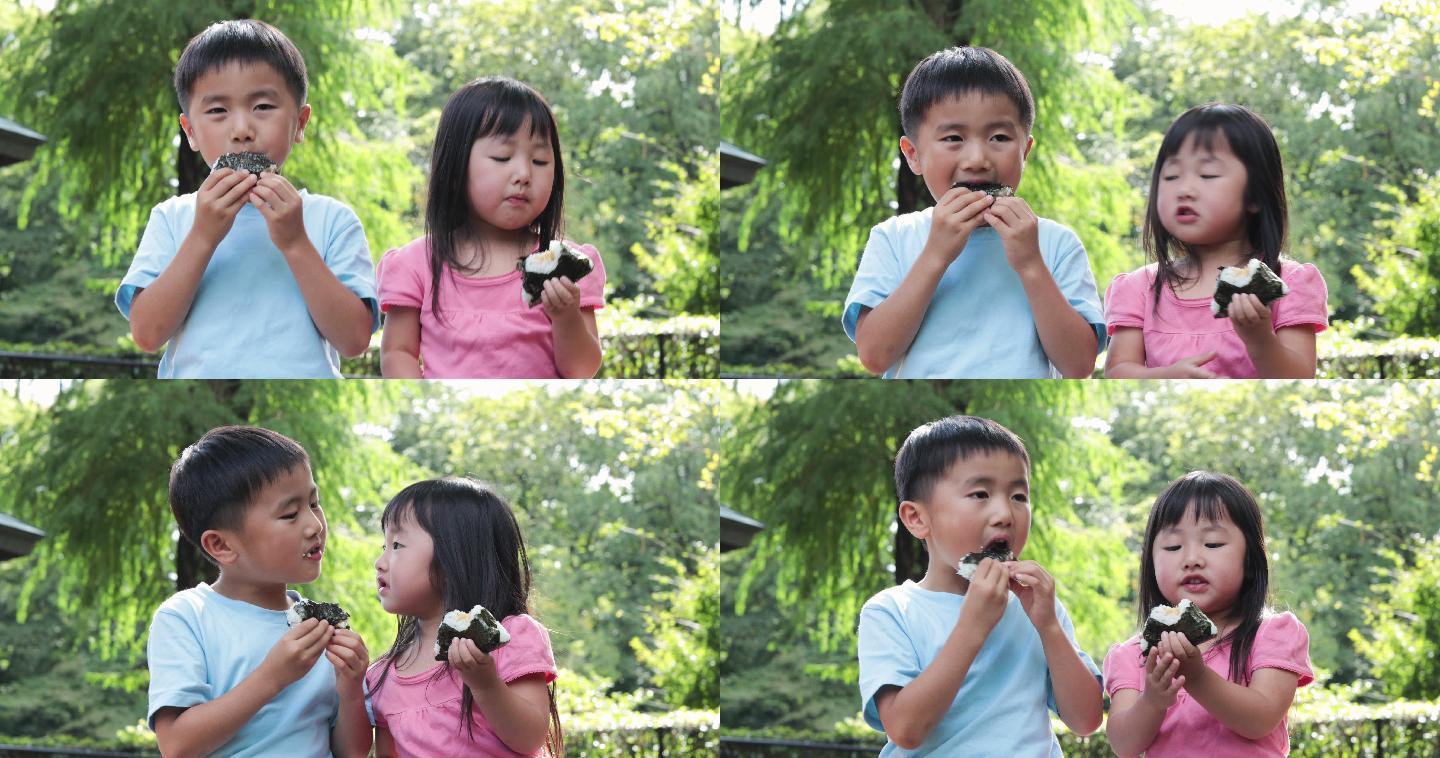 孩子在户外吃饭团日本小学生孩子日式美食