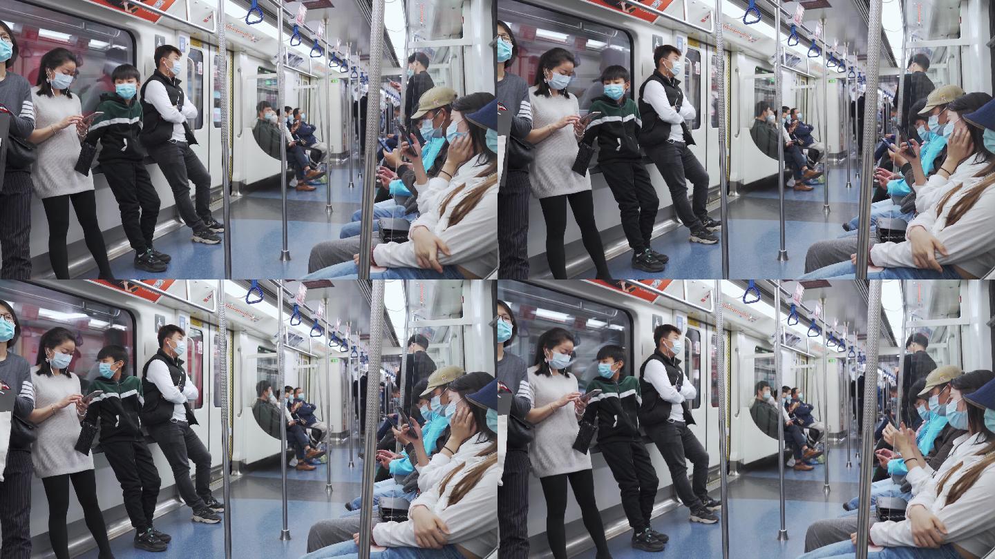 地铁上戴口罩用手机的年轻人