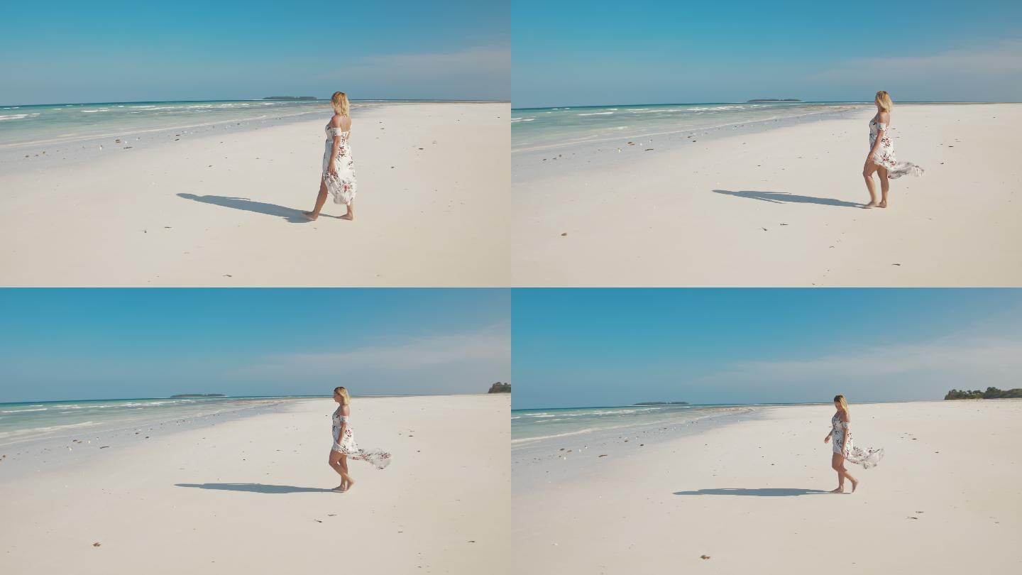 穿着长裙在沙滩上散步女子