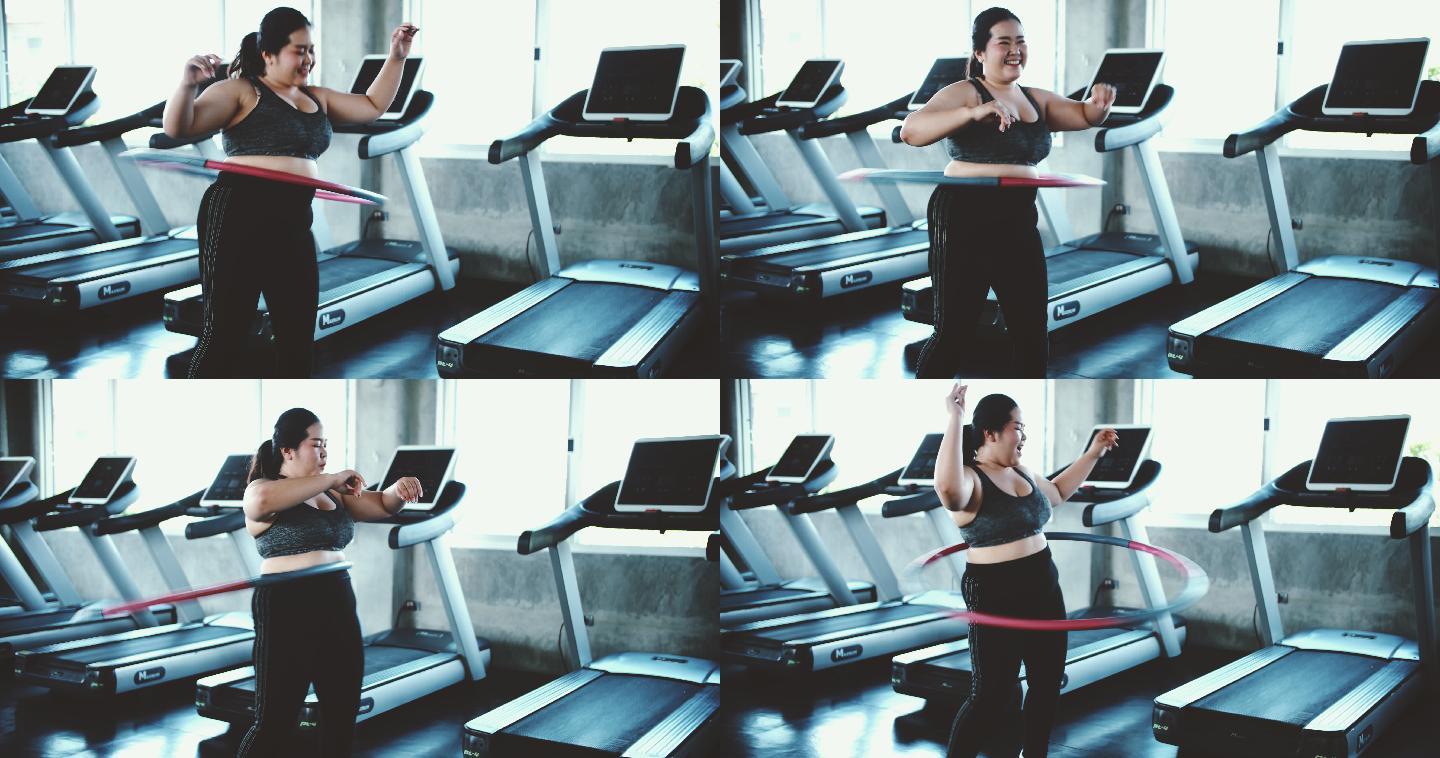 在锻炼的女人摇呼啦圈的女人胖女人减肥训练