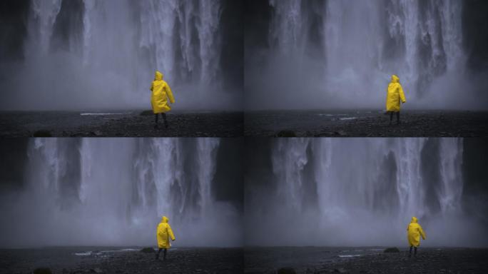 穿着黄色雨衣的女人在冰岛发现了瀑布
