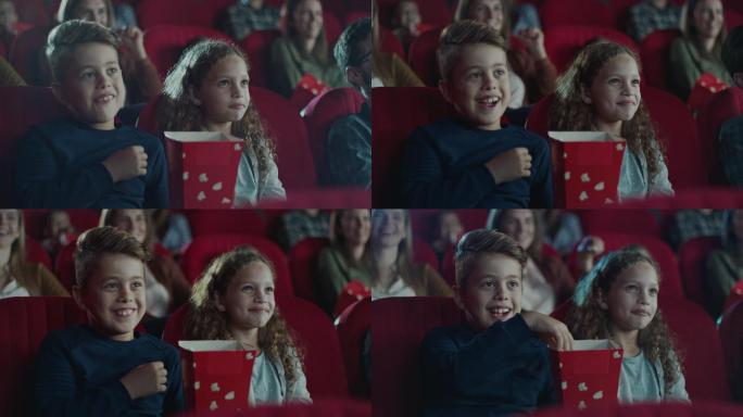 男孩和女孩在电影院吃爆米花看电影