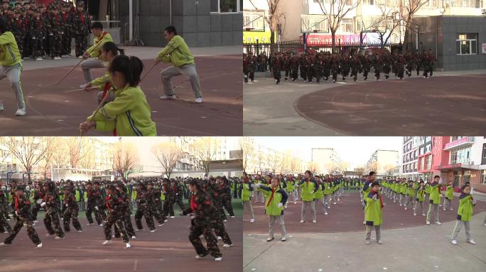 小学生在操场上表演军体拳擒拿棍棒表演