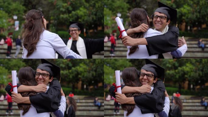 年轻的男学生在大学获得学位后拥抱他的母亲