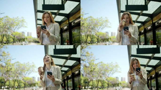女人玩着手机在公交站等车