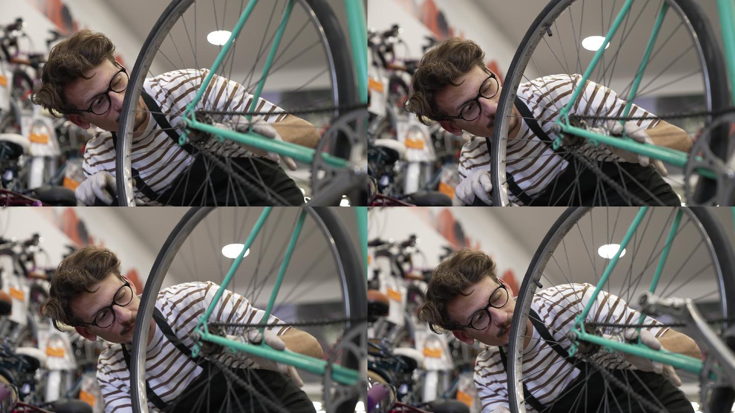 年轻人在他的自行车店修理自行车