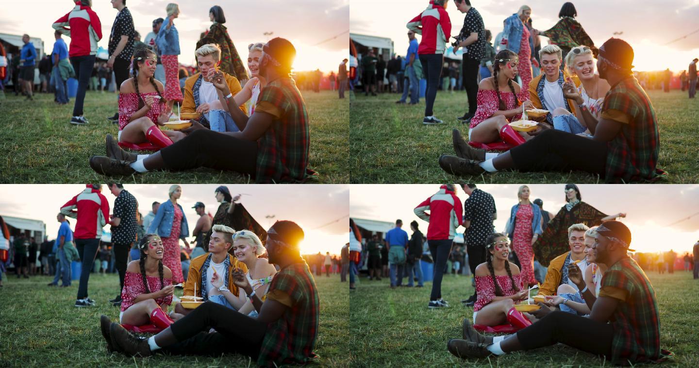 一群朋友在野外的音乐节帐篷外吃饭。