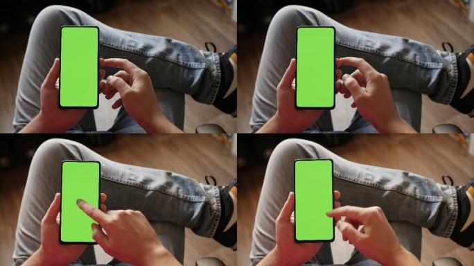 男子用绿色模拟屏幕扫描智能手机上的指纹