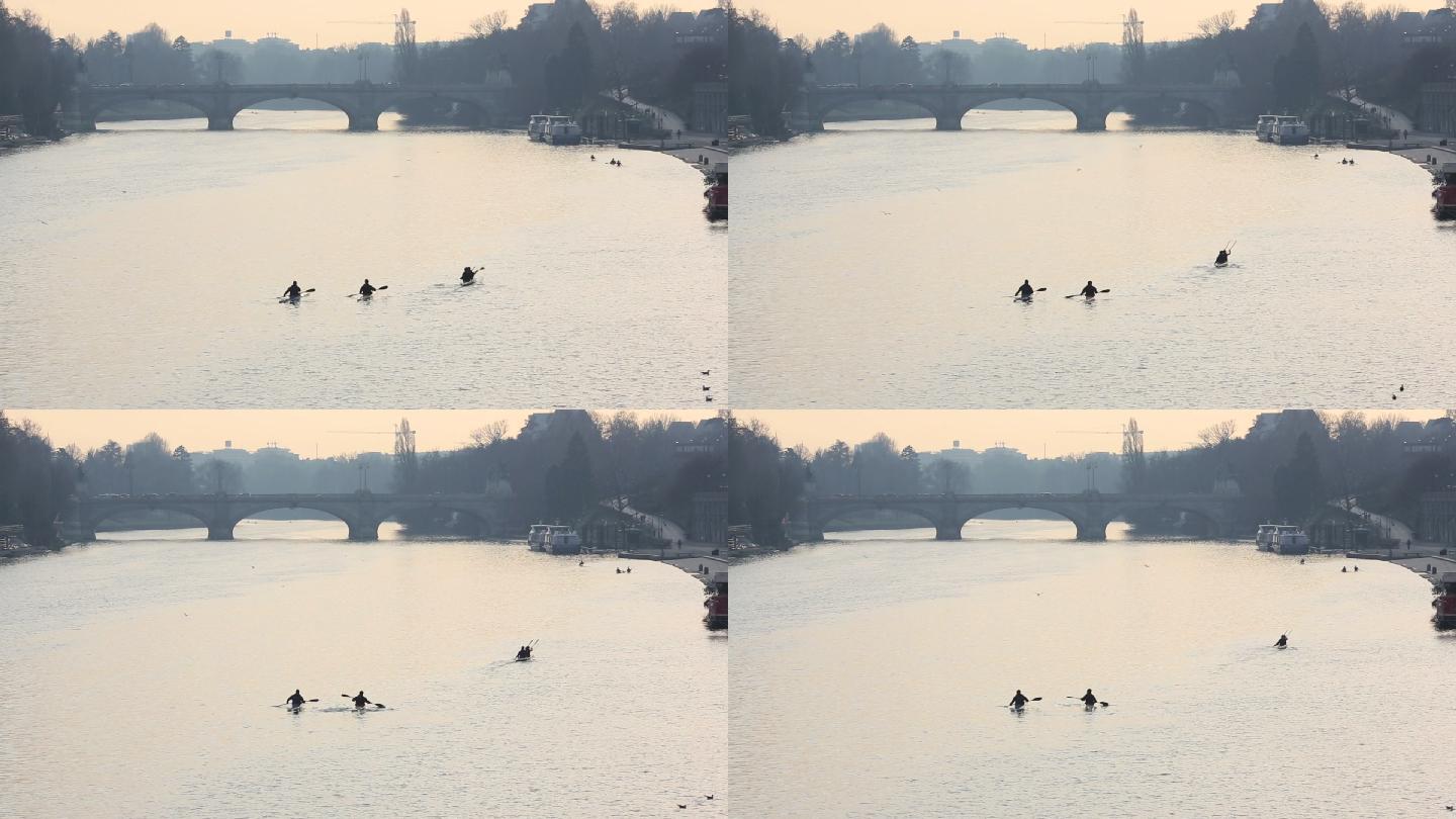 远处的皮划艇运动员沿着河道逆流而上