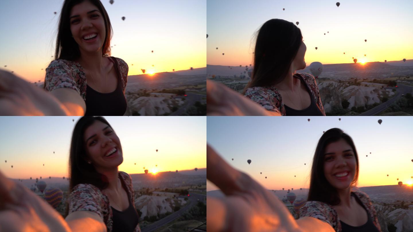 游客自拍热气球飞行山脉夕阳日出日落