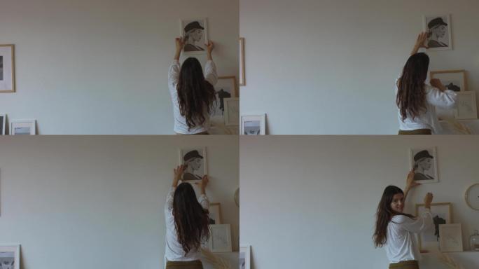 快乐的女孩在室内白墙上挂着画