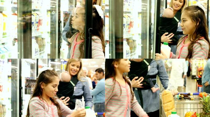 女孩帮助母亲在超市购物