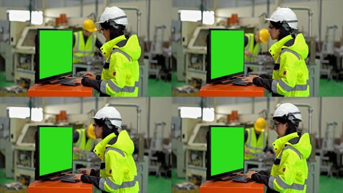 女工业工程师使用带有绿色屏幕显示器的电脑