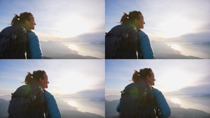 登上山顶的女子攀登征程峰顶日出极致体验