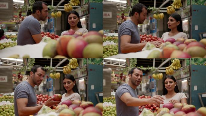 夫妇在农贸市场买水果，谈笑风生