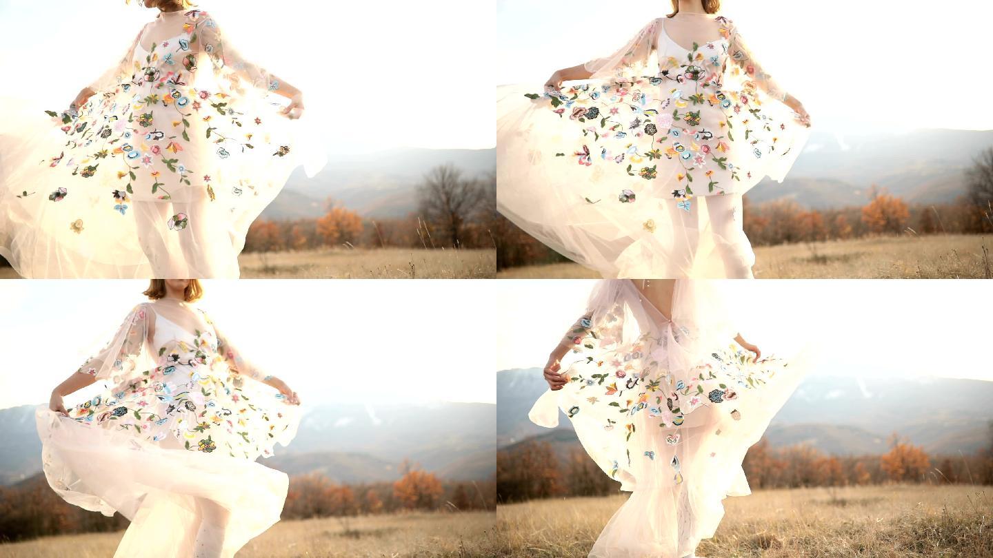 年轻的女孩在草地上跳舞，穿着白色花裙旋转