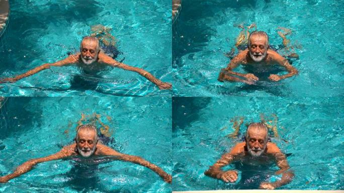 在室外游泳池游泳的老人