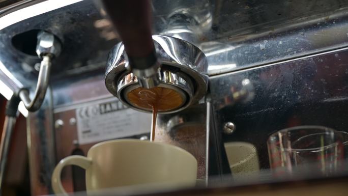 咖啡机上的无底过滤网将浓缩咖啡倒入咖啡杯
