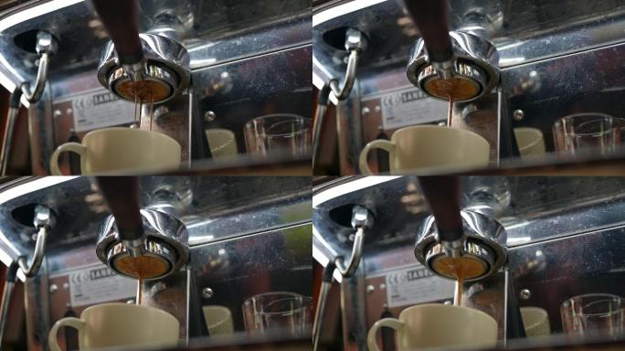 咖啡机上的无底过滤网将浓缩咖啡倒入咖啡杯