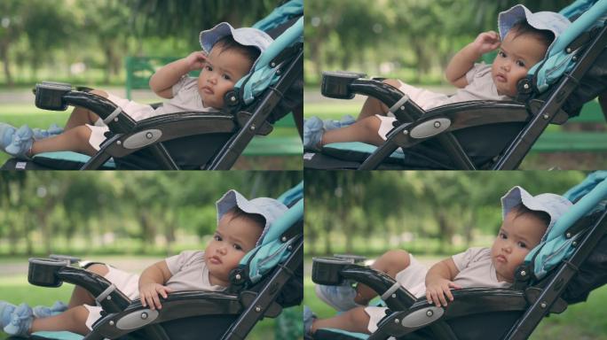 婴儿车上的女婴不开心的小宝宝悠闲童年儿童