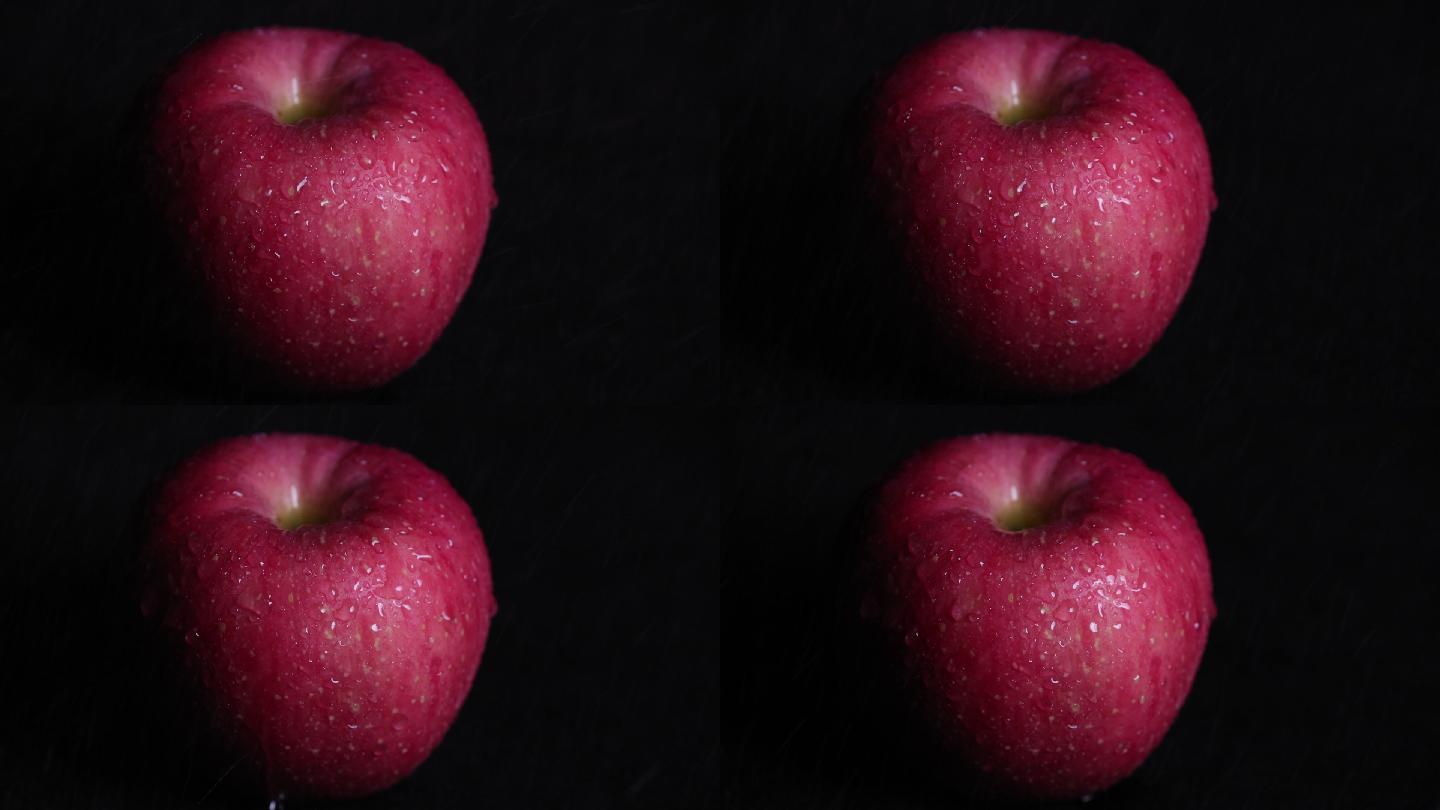 黑背景水滴在苹果上滑落