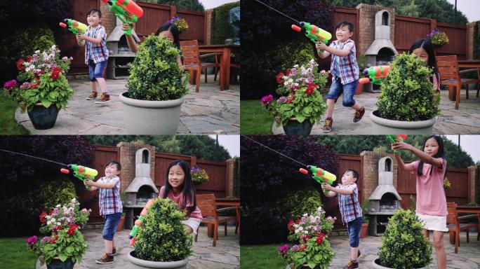 在花园里打水仗小孩子玩耍小学生玩水枪