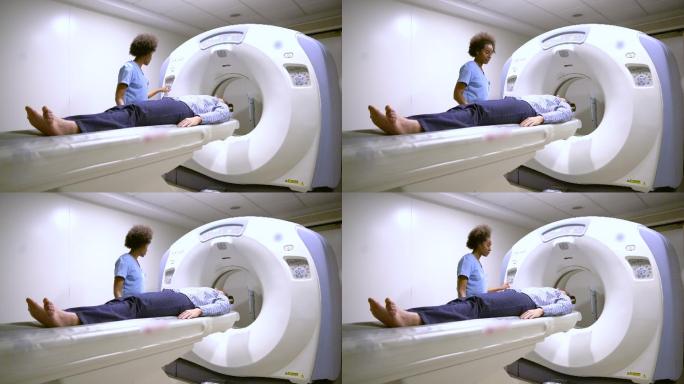 放射科医生为男子做核磁共振扫描准备