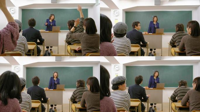 在一间教室里，一位老师向一群成年学生演讲