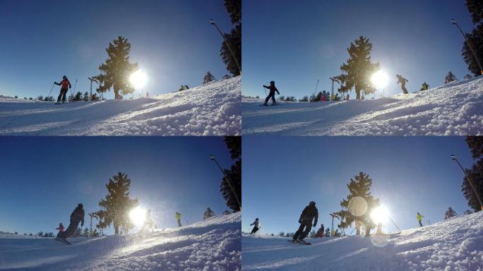 阳光照射在雪地滑雪坡上的滑雪者身上