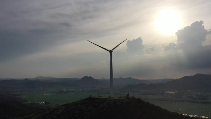 朝阳之下逆光大广角航拍山地新能源风力发电