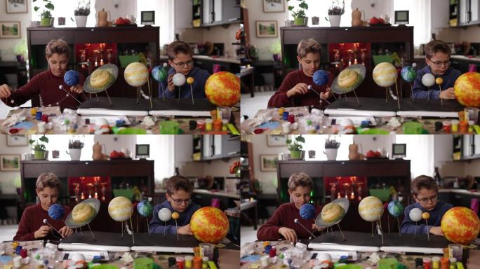 小男孩在家制作太阳系模型