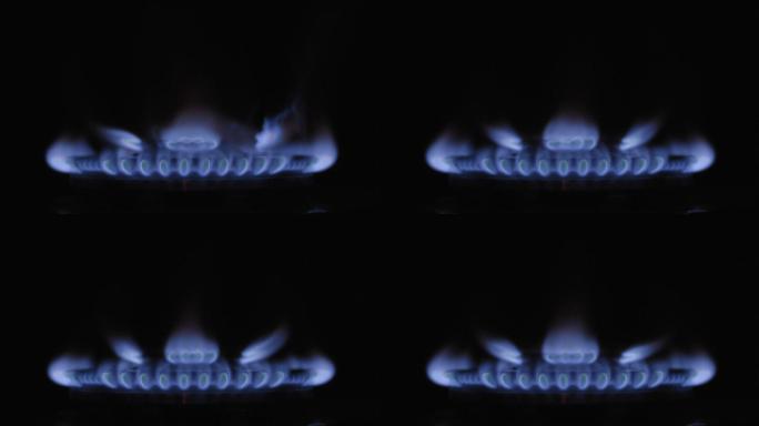 煤气打开了，在黑暗中出现了燃烧器的蓝色火焰