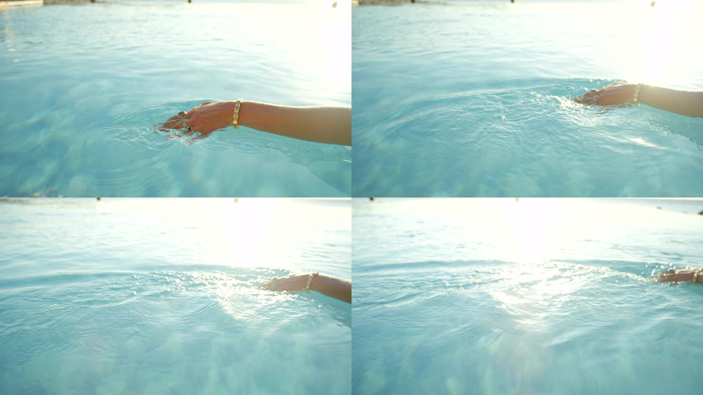 女人用手指在玻璃般的水面上滑动