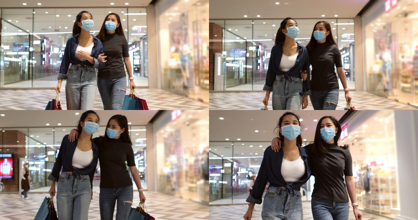 女人戴着卫生口罩，手里拿着购物袋逛商场