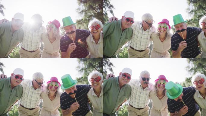 公园里一群戴着有趣眼镜和帽子的快乐老人