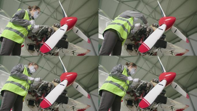 飞机工程师在飞机库检查飞机发动机