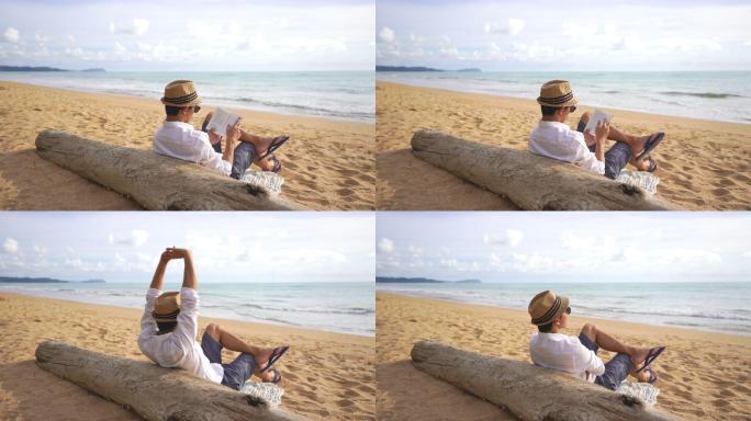 在沙滩上看书的男人