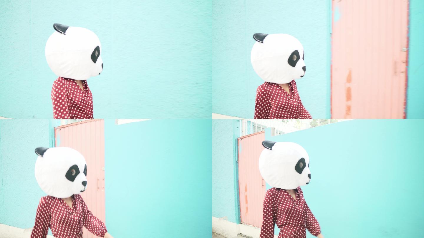穿着熊猫服装的年轻女子自信地走在街上