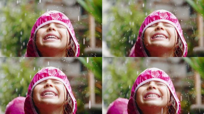 一个快乐的女孩在雨中玩耍