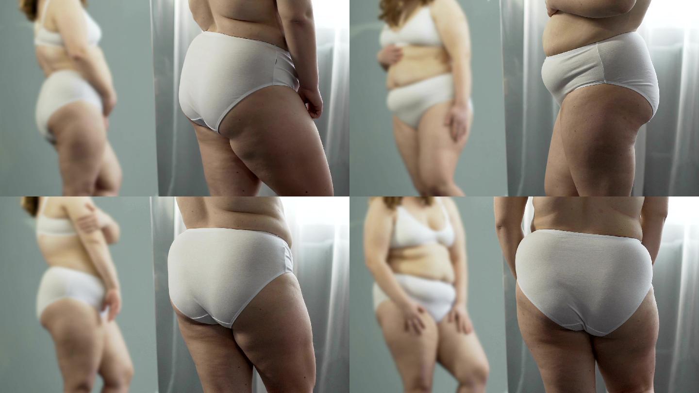 胖乎乎的女性在镜子前抚摸着她的身体