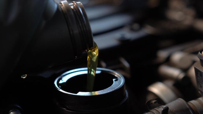 将新的清洁合成油注入汽车发动机