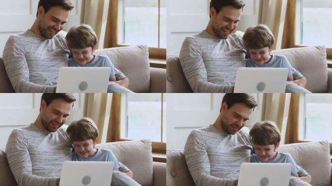 小孩在电脑上和爸爸玩游戏。