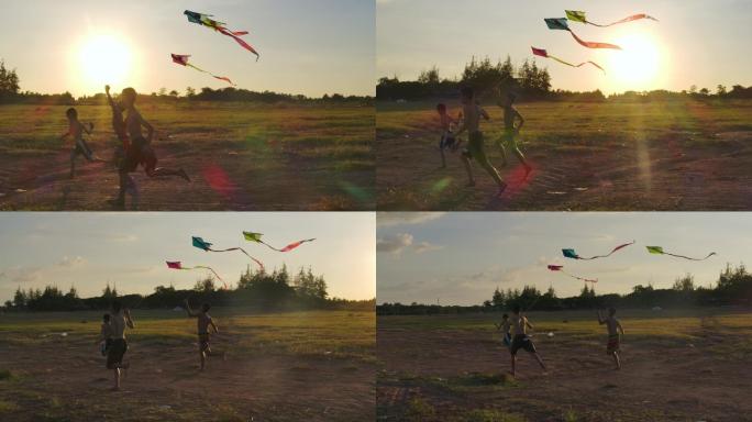日落时分，三个孩子拿着风筝在乡村奔跑。