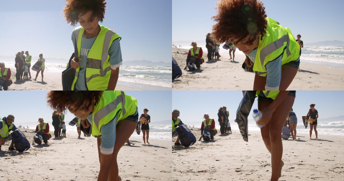女性志愿者在阳光明媚的日子清洁海滩4k