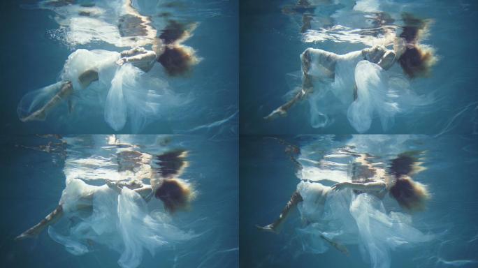 金发女郎漂浮在美丽神秘的水下世界。