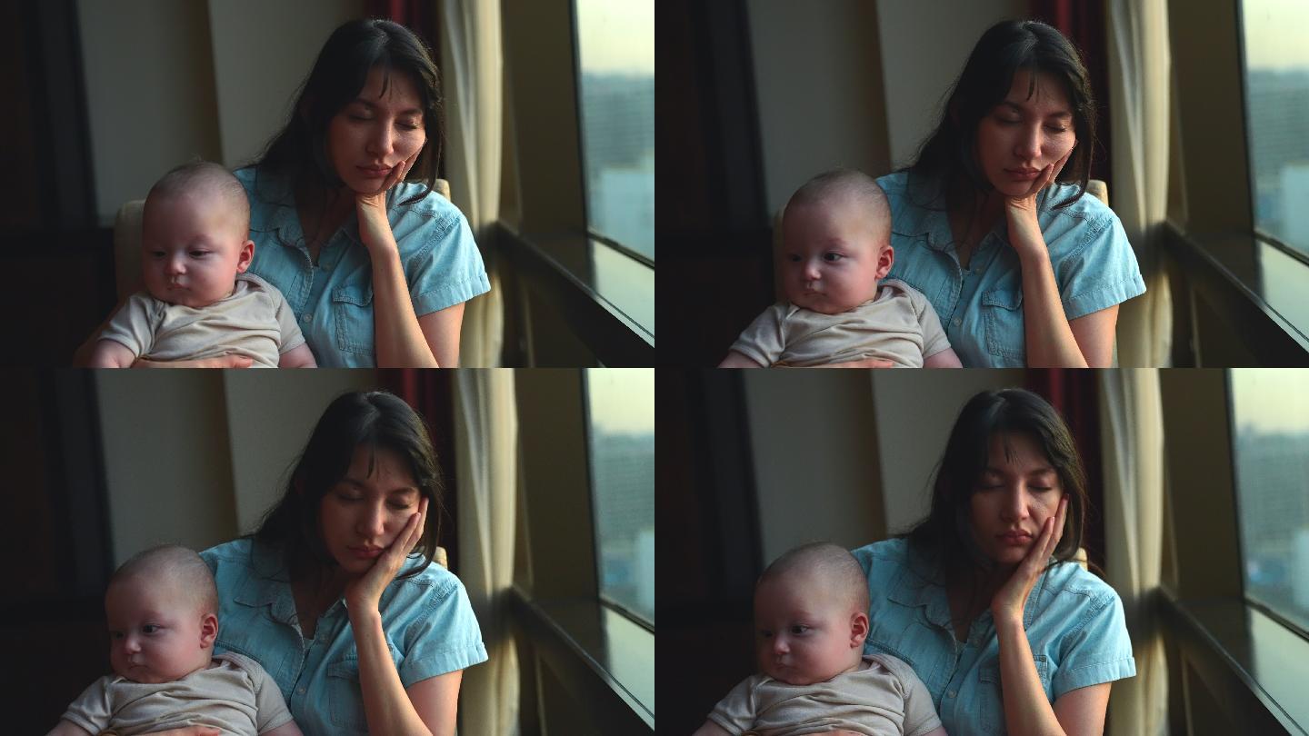 一位独自抚养婴儿的母亲看起来疲惫不堪
